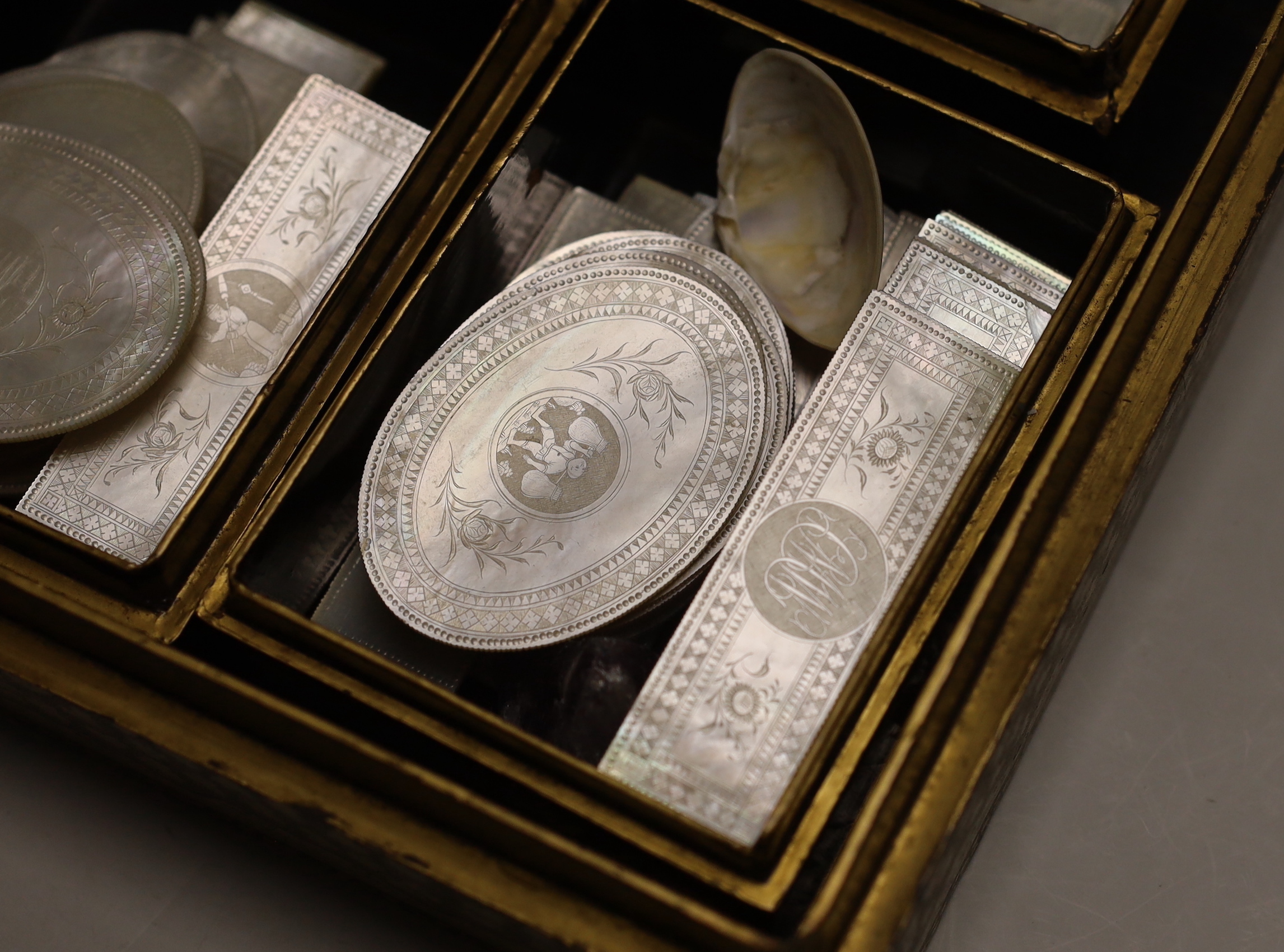 A 19th century Chinese export lacquer games box and mother of pearl counters